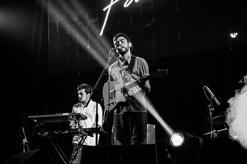 Black and white photo of a musician performing on stage